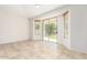 Versatile bonus room with tile flooring, sliding glass door access to the backyard, and plenty of natural light at 4520 N 151St Dr, Goodyear, AZ 85395