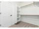 Walk-in closet with white shelving, carpet flooring, and ample storage space at 4520 N 151St Dr, Goodyear, AZ 85395