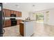 Well-lit kitchen boasts modern appliances, granite countertops, tile floors, and direct access to the backyard at 4520 N 151St Dr, Goodyear, AZ 85395