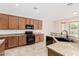 Featuring granite countertops, tile floors, and modern appliances, this kitchen is ready for cooking at 4520 N 151St Dr, Goodyear, AZ 85395