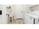 Laundry room with wash sink, washing machine and tiled flooring at 4520 N 151St Dr, Goodyear, AZ 85395