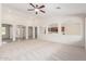 Bright, airy living room featuring neutral walls, carpet, and open access to the kitchen and entryway at 4520 N 151St Dr, Goodyear, AZ 85395