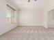 Main bedroom with neutral carpet, ceiling fan, and window that allows natural sunlight into the room at 4520 N 151St Dr, Goodyear, AZ 85395