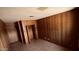 Spacious bedroom boasts wood paneling and an open closet with ample storage solutions for convenience at 461 N Cheri Lynn Dr, Chandler, AZ 85225