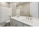 Primary bathroom with double sink vanity, a large mirror, and tub with shower at 5815 E Covey Ln, Phoenix, AZ 85054