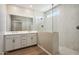 Luxurious bathroom with double vanity, modern fixtures, and a glass-enclosed shower with built-in bench at 5815 E Covey Ln, Phoenix, AZ 85054