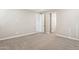 Large, neutral carpeted bedroom with white baseboards, and natural light, with open white door way at 5815 E Covey Ln, Phoenix, AZ 85054