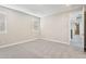Spacious carpeted bedroom with base trim, a large window for natural light, and neutral walls at 5815 E Covey Ln, Phoenix, AZ 85054