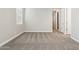 Neutral bedroom with carpet, base trim, natural light from the window, and two access doors at 5815 E Covey Ln, Phoenix, AZ 85054