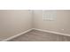 Bedroom featuring carpeted floors, neutral-colored walls, and a bright window at 5815 E Covey Ln, Phoenix, AZ 85054