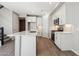 Modern kitchen features white cabinets, stainless steel appliances, and a center island with stone countertops at 5815 E Covey Ln, Phoenix, AZ 85054