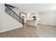 Open floor plan featuring tile floors, kitchen with island, and a staircase with iron railing to the second floor at 5815 E Covey Ln, Phoenix, AZ 85054