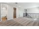 Spacious loft area with plush carpeting, featuring a stylish black metal railing at 5815 E Covey Ln, Phoenix, AZ 85054