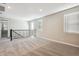 Bright loft area with plush carpeting and black railing, illuminated by natural light at 5815 E Covey Ln, Phoenix, AZ 85054