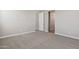 A carpeted bedroom is painted with a light gray and has two doors to connect with other rooms at 5831 E Covey Ln, Phoenix, AZ 85054