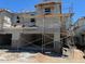 New construction of a two-story home with stucco exterior and scaffolding around the facade at 5831 E Covey Ln, Phoenix, AZ 85054