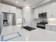 Kitchen featuring stainless steel appliances, quartz countertops, white cabinets, and recessed lighting at 5831 E Covey Ln, Phoenix, AZ 85054