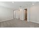 A loft area upstairs has carpet and three doors and windows that provide lots of light at 5831 E Covey Ln, Phoenix, AZ 85054