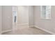 A room with beige painted walls and flooring has a view to a gray railing and a window to the right at 5831 E Covey Ln, Phoenix, AZ 85054
