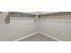 This walk-in closet features metal rods for hanging clothes at 5831 E Covey Ln, Phoenix, AZ 85054
