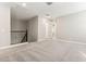 This bedroom features neutral walls, plush gray carpet, and a railing overlooking a stairwell at 5839 E Covey Ln, Phoenix, AZ 85054