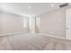 A well-lit bedroom with neutral walls, plush gray carpet, and a large window for ample natural light at 5839 E Covey Ln, Phoenix, AZ 85054