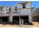 New construction home featuring a two-story design and attached garages with scaffolding at 5839 E Covey Ln, Phoenix, AZ 85054