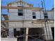 Exterior of home under construction featuring white facade, windows, two-car garage, and temporary scaffolding at 5851 E Covey Ln, Phoenix, AZ 85054