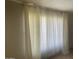 Bright living room featuring large window with light filtering curtains at 6029 N 31St Ave, Phoenix, AZ 85017
