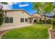 Well-maintained backyard features green lawn and a covered patio ideal for outdoor entertaining and relaxation at 6300 S Nash Way, Chandler, AZ 85249