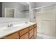 Bathroom featuring double sinks and a glass-enclosed shower at 6300 S Nash Way, Chandler, AZ 85249