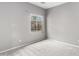 Bedroom features neutral paint, carpet, and a window overlooking a garden at 6300 S Nash Way, Chandler, AZ 85249