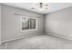 Neutral bedroom with a ceiling fan, carpet, and a window overlooking a green yard at 6300 S Nash Way, Chandler, AZ 85249