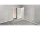 Neutral-toned bedroom with gray carpet and white doors to the closet and ensuite at 6300 S Nash Way, Chandler, AZ 85249