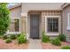 Inviting front entrance with security door, desert landscaping, and decorative window boxes at 6300 S Nash Way, Chandler, AZ 85249