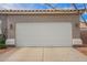 Exterior view of a two-car garage door with the house number on the facade at 6300 S Nash Way, Chandler, AZ 85249
