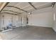 Spacious garage with a concrete floor, white walls, and built-in storage shelving at 6300 S Nash Way, Chandler, AZ 85249