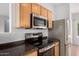 Modern kitchen boasts sleek stainless steel appliances and efficient design at 6300 S Nash Way, Chandler, AZ 85249