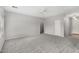 Inviting living room features plush carpet, neutral paint, and a seamless flow to other living spaces at 6300 S Nash Way, Chandler, AZ 85249