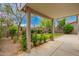 Covered patio area overlooking a well-maintained backyard with green grass and landscaping at 6300 S Nash Way, Chandler, AZ 85249