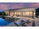 Stunning backyard oasis with a pool, covered patio, outdoor seating, and lush landscaping for ultimate relaxation at 6481 E Amber Sun Dr, Scottsdale, AZ 85266