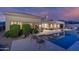 Serene backyard featuring a sparkling pool, covered patio, and mature landscaping, perfect for relaxation and entertaining at 6481 E Amber Sun Dr, Scottsdale, AZ 85266