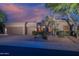 Charming home featuring a desert landscape, three-car garage, and neutral color palette at 6481 E Amber Sun Dr, Scottsdale, AZ 85266