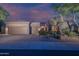 Charming home featuring a desert landscape, three-car garage, and neutral color palette at 6481 E Amber Sun Dr, Scottsdale, AZ 85266