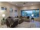 Open living area with neutral colors, a ceiling fan and large windows overlooking the backyard at 6481 E Amber Sun Dr, Scottsdale, AZ 85266