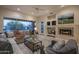Cozy living room features a fireplace, large windows, and comfortable seating at 6481 E Amber Sun Dr, Scottsdale, AZ 85266