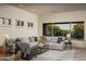 Open living area with neutral colors, a ceiling fan and large windows overlooking the backyard at 6481 E Amber Sun Dr, Scottsdale, AZ 85266