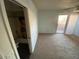 Bright bedroom with carpet, ensuite bathroom and sliding door to exterior deck at 6911 W Devonshire Ave # 1269, Phoenix, AZ 85033