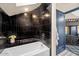 Modern bathroom featuring a black tiled shower and tub combination with a unique stone seat at 8219 S Pecan Grove Cir, Tempe, AZ 85284