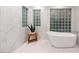Bright bathroom showcasing a freestanding tub, marble walls and decorative glass block windows at 8219 S Pecan Grove Cir, Tempe, AZ 85284